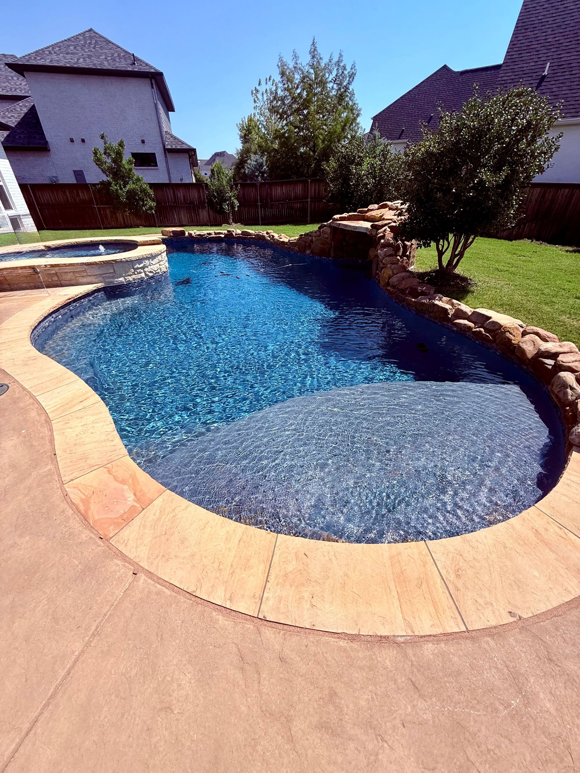 Pool with spa and rock waterfall — McKinney TX