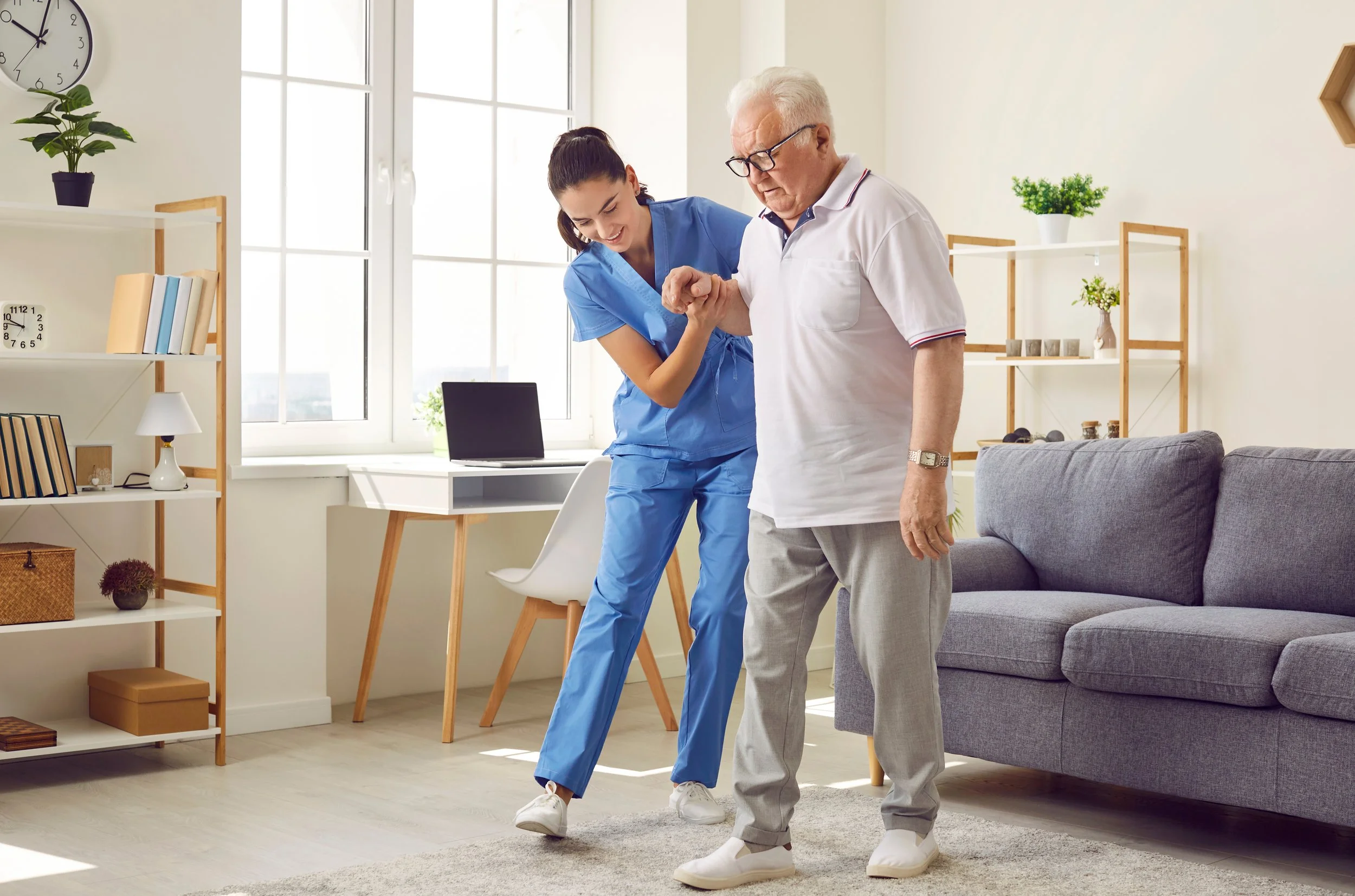 Physiotherapist assisting elderly patient with walking